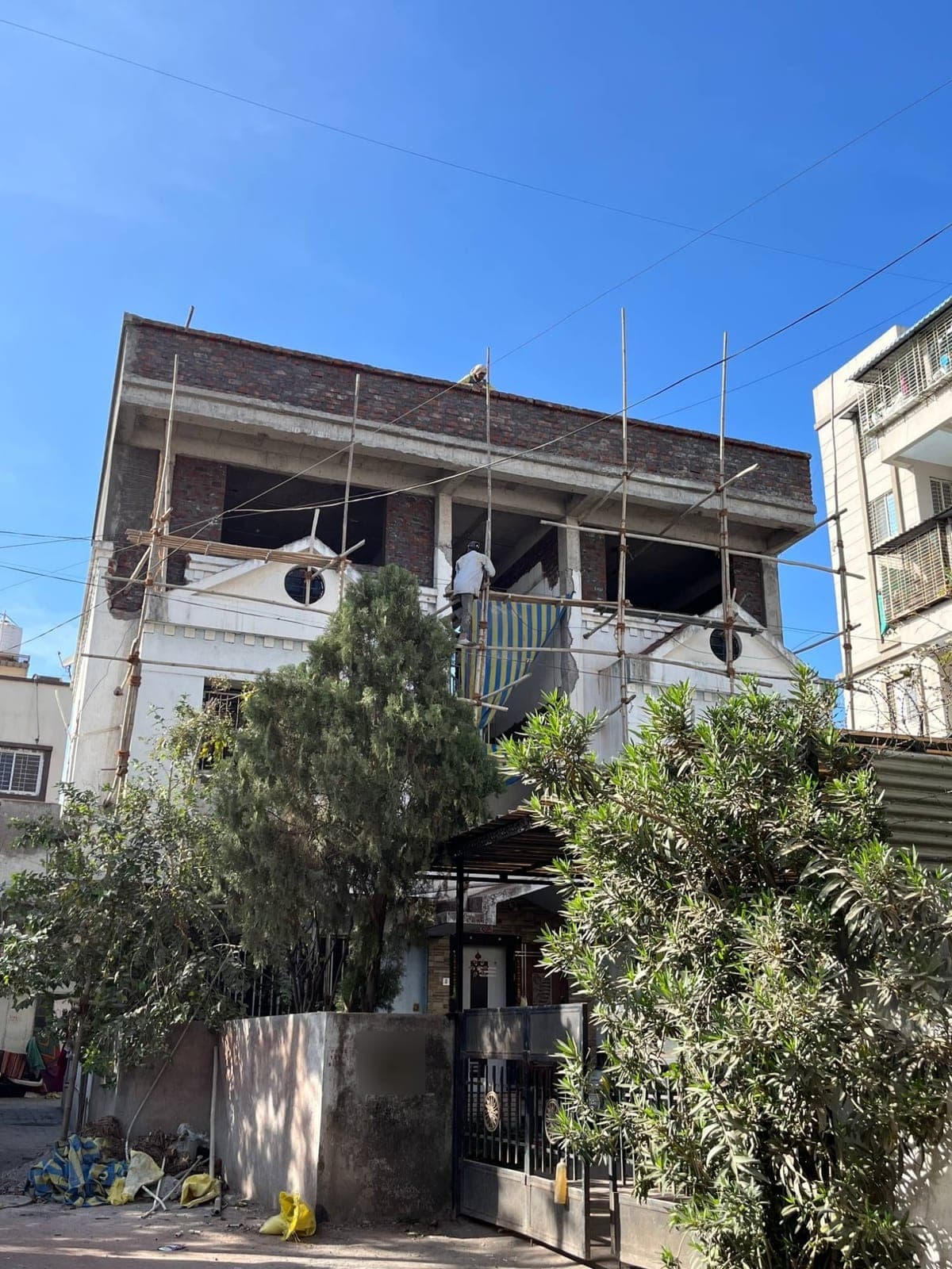 New upper storey rising over the old facade — Padale House, Kalewadi, Pune