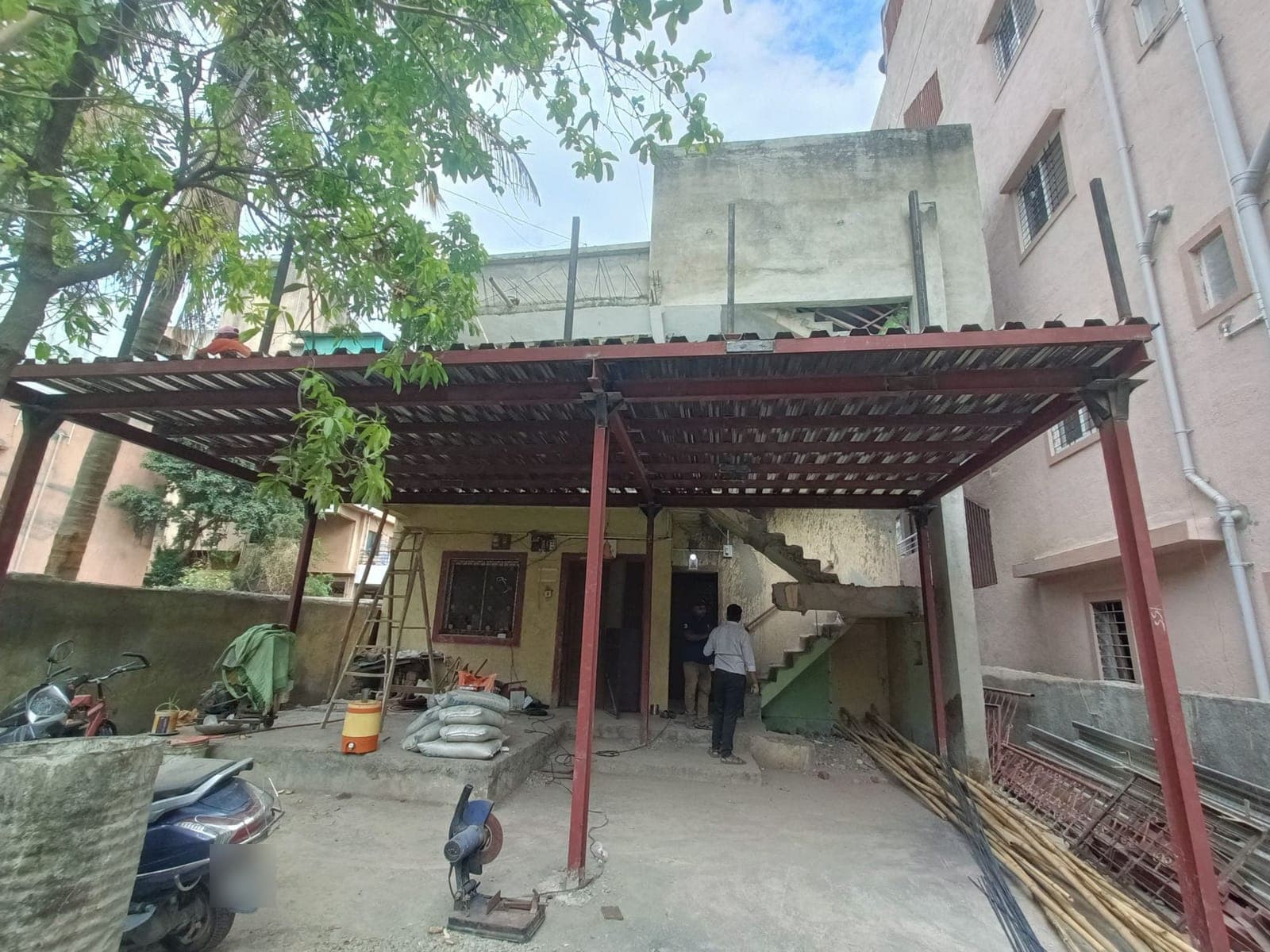 Steel frame over the existing house — Tandale House, Lohegaon, Pune